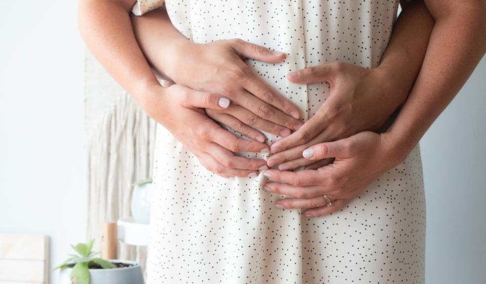 picture of pregnant woman holding her bump