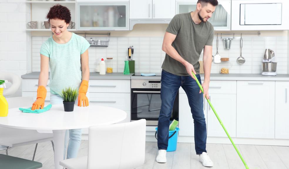 Man and a woman cleaning their kitchen
