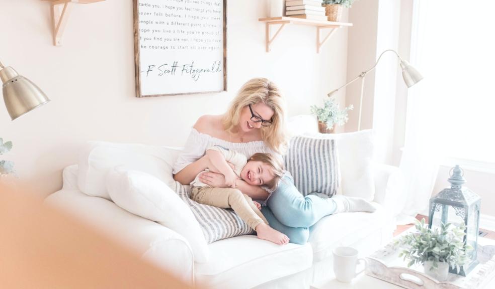 picture of a mum and child on a sofa laughing