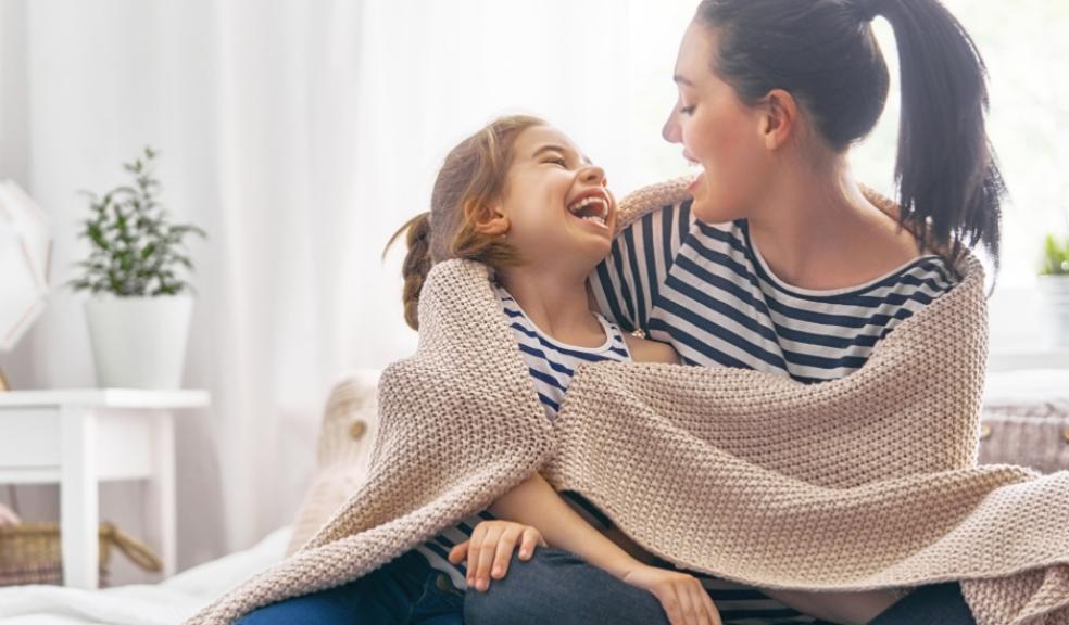 picture of mum and child wrapped in blanket