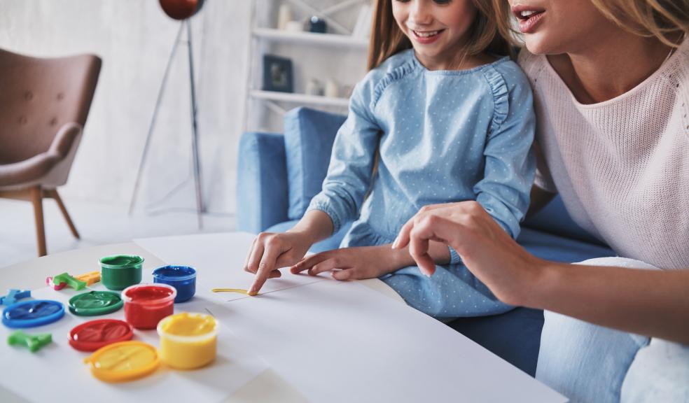 Mum and daughter doing a finger painting activity
