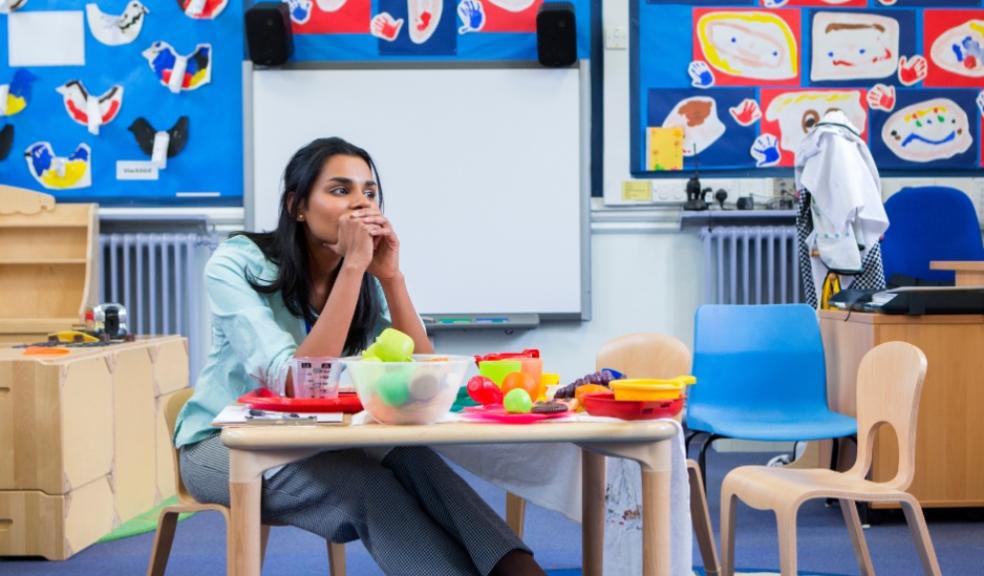 picture of a nursery teacher sat in a classroom
