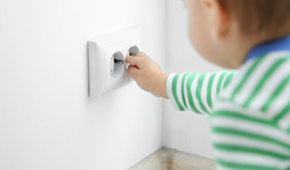 picture of a toddler with a plug socket