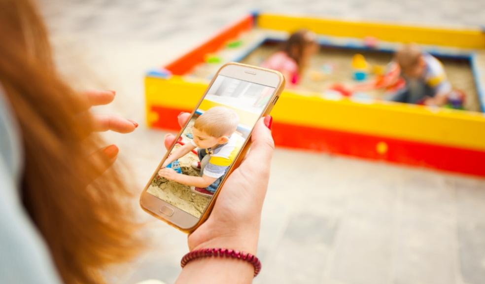 parent sharing a picture of their child online picture of a parent sharing a picture of their child online