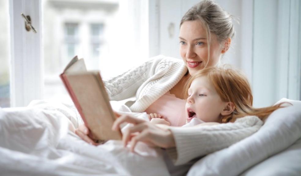 Picture of a mother and child reading a book together