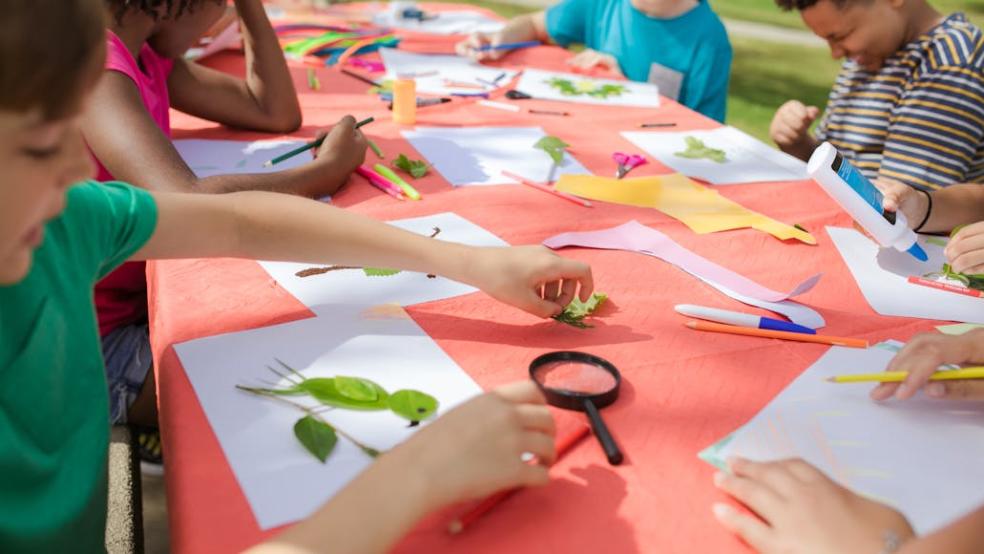 Kids Making Artworks on a Table outdoors