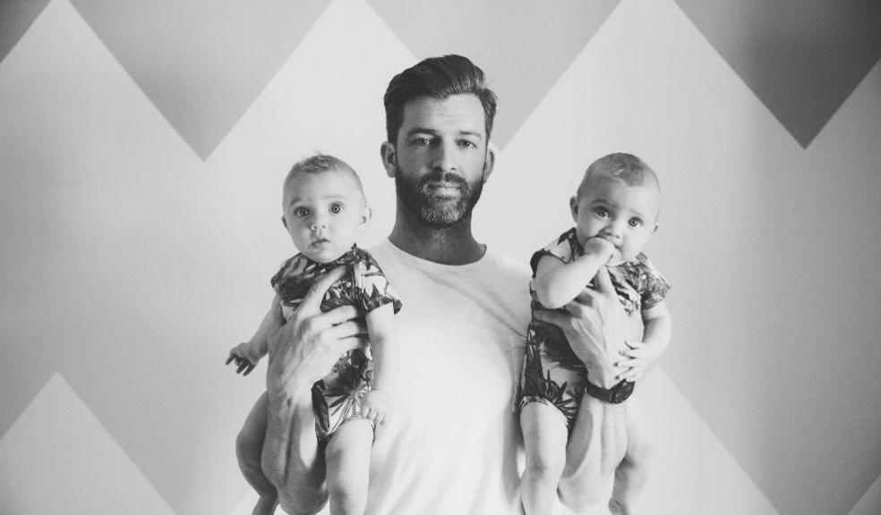 picture of a man holding two babies