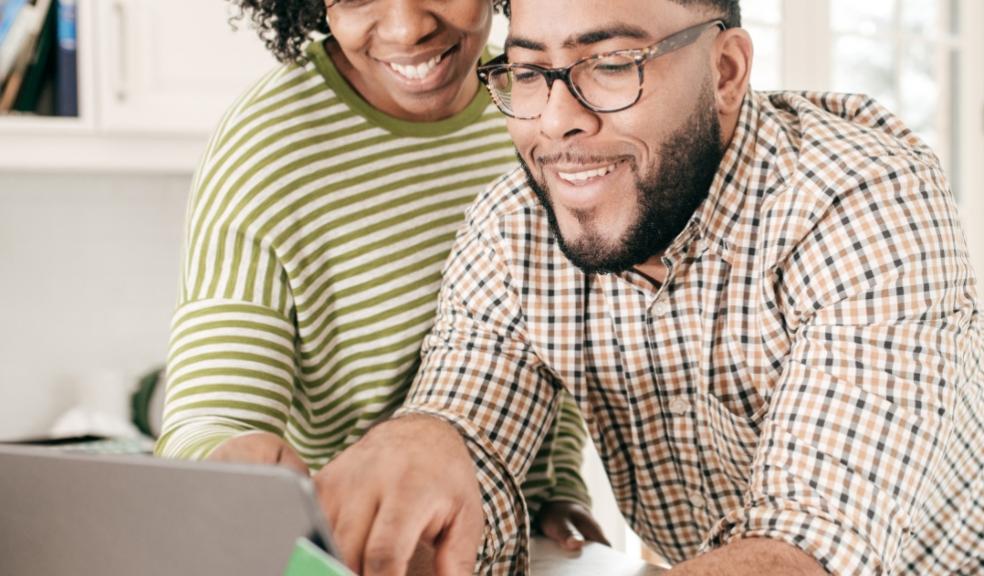 picture of a couple looking at a laptop