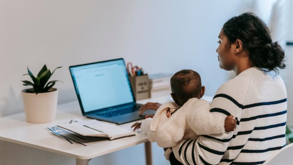 picture of a mum working from home with a baby on her lap