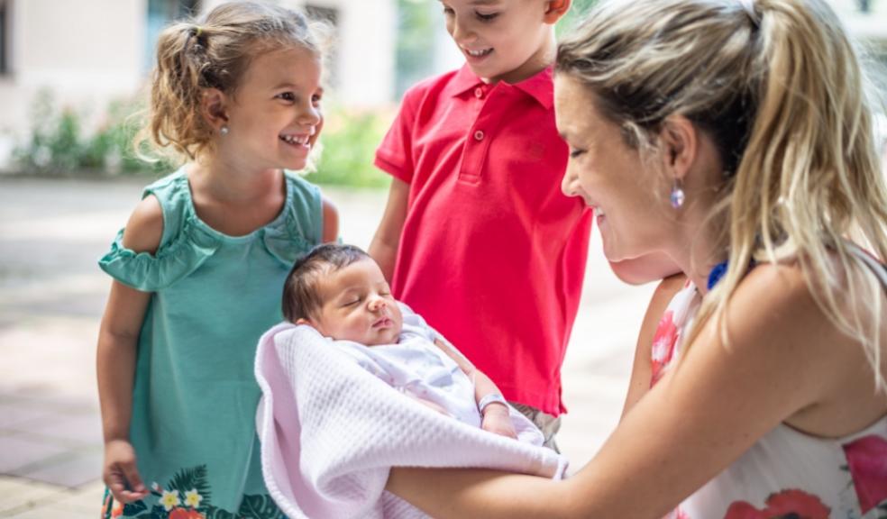 picture of children meeting their newborn sibling