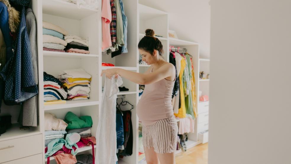 picture of pregnant woman looking in her wardrobe
