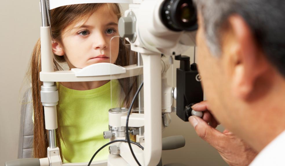 Picture of a child having her eyes tested at an opticians