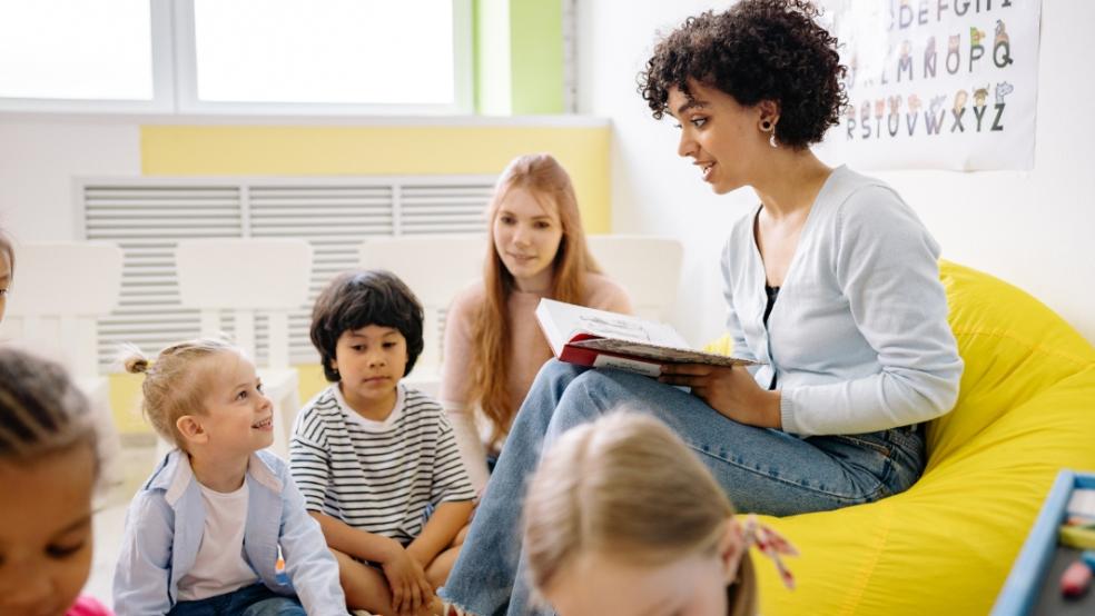 picture of teacher reading to primary children