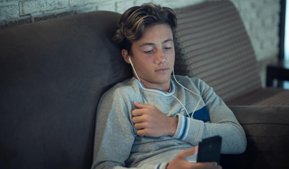 picture of a teen boy watching his phone