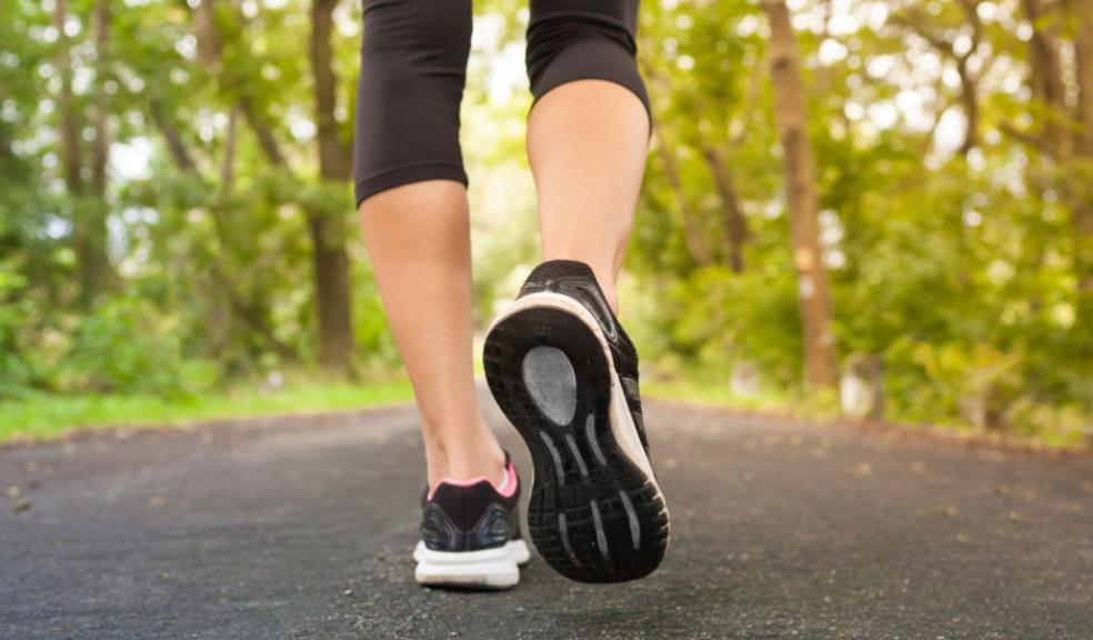 woman walking outside to improve her health picture of a woman walking outside to improve her health
