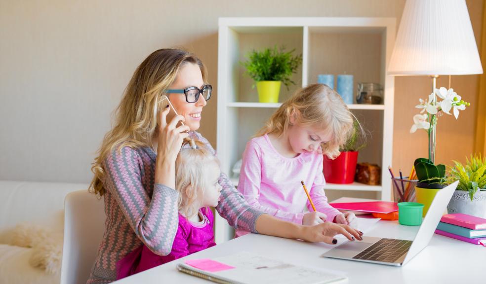 Picture of a mum working from home with two small children
