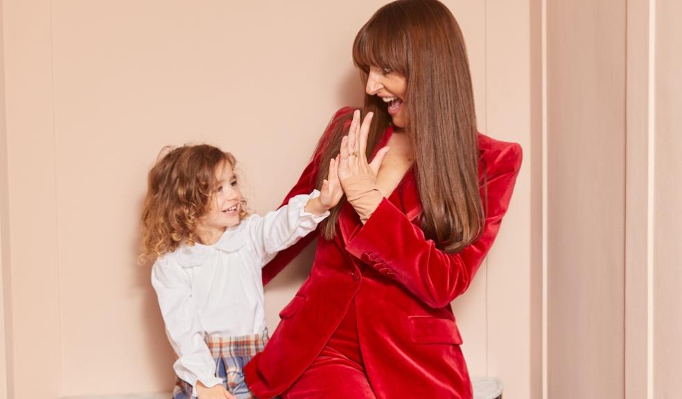 picture of a working mum in a red suit with her child
