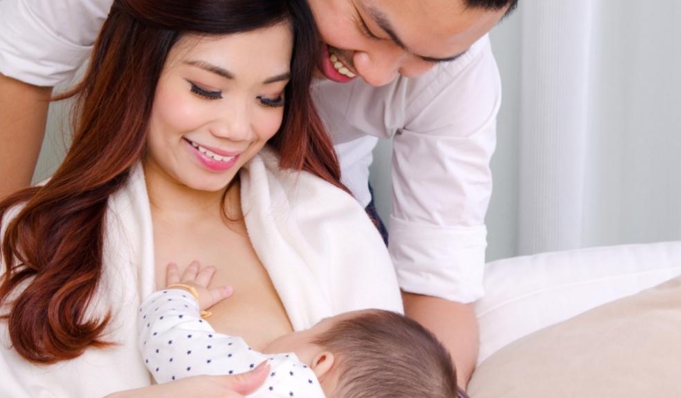 picture of a breastfeeding mum being supported by her partner