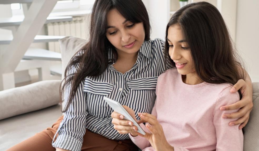picture of a parent and child using a smart device