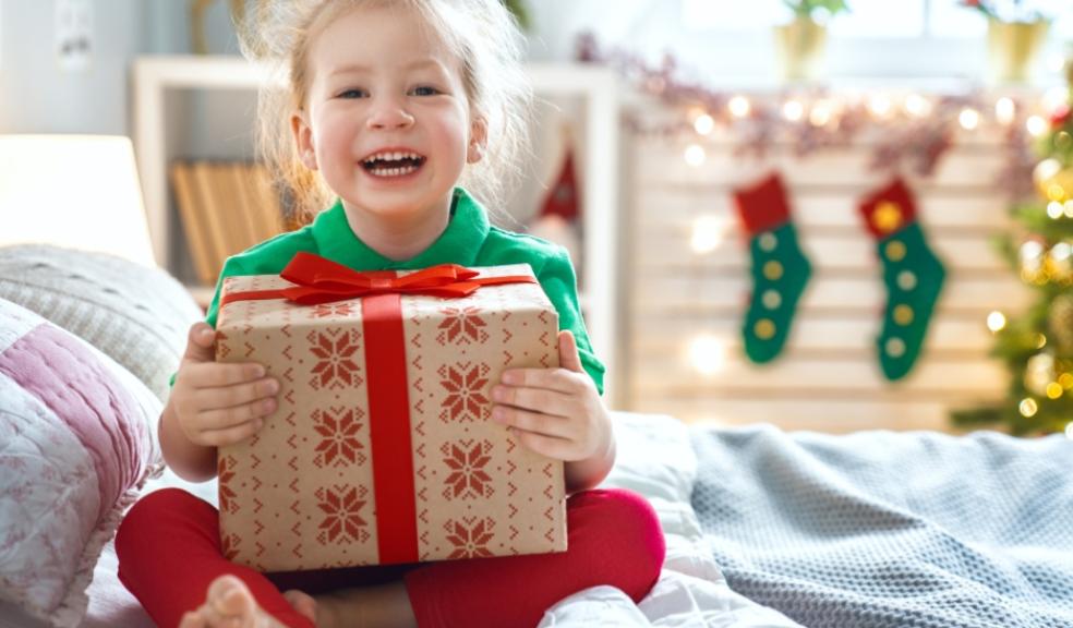 picture of a happy child receiving a christmas present
