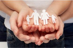 picture of hands together showing a paper cut out of a family