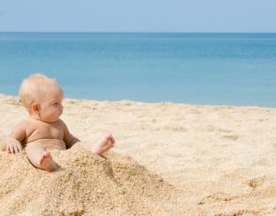 picture of a baby on a sunny beach