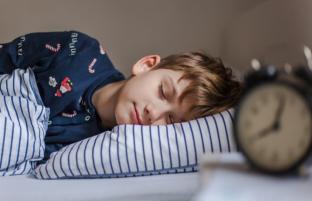 picture of boy child asleep in bed