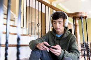 picture of boy on headphones and smartphone