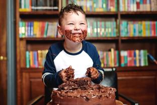 picture of a child eating chocolate cake