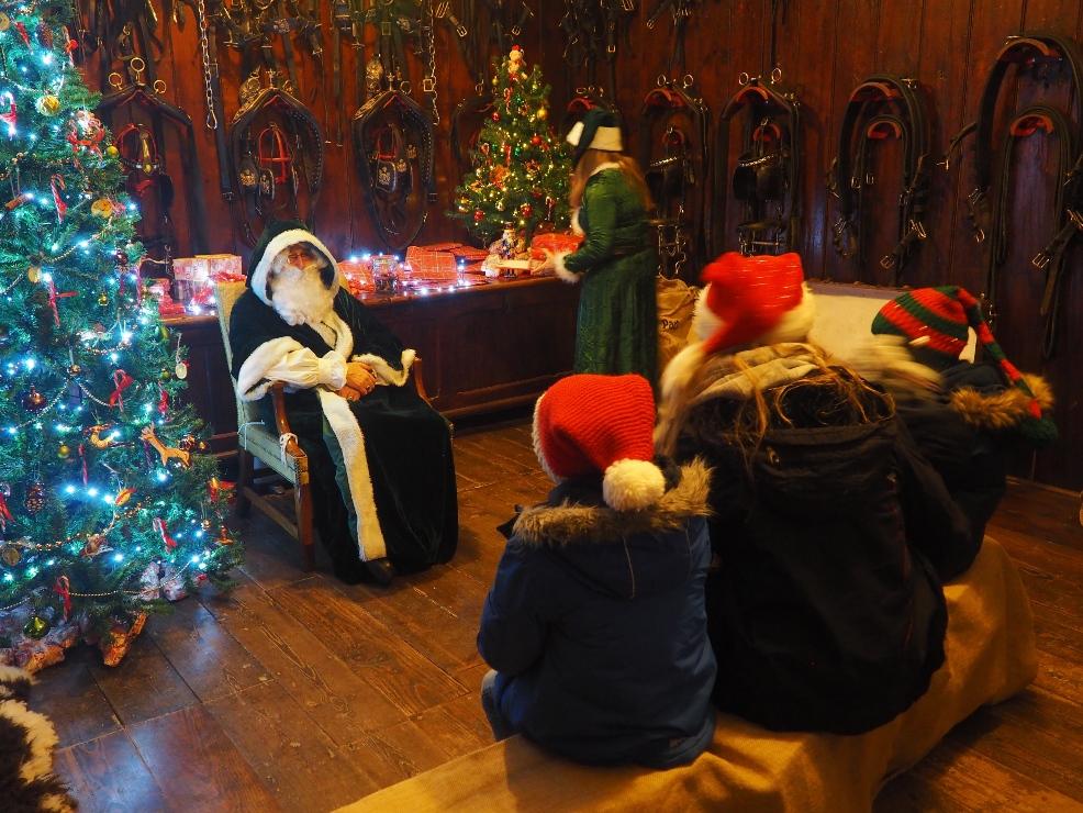 picture of A family meeting Father Christmas in the Santas Grotto at Arlington Court and Carriage Museum Devon