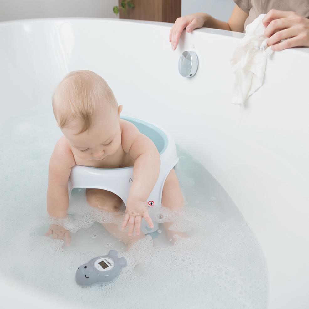 picture of baby in a bath with bath thermometer