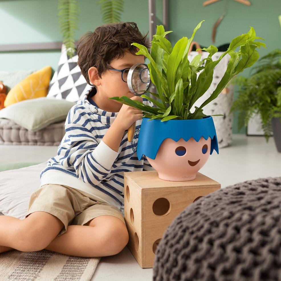 picture of a child looking after a houseplant