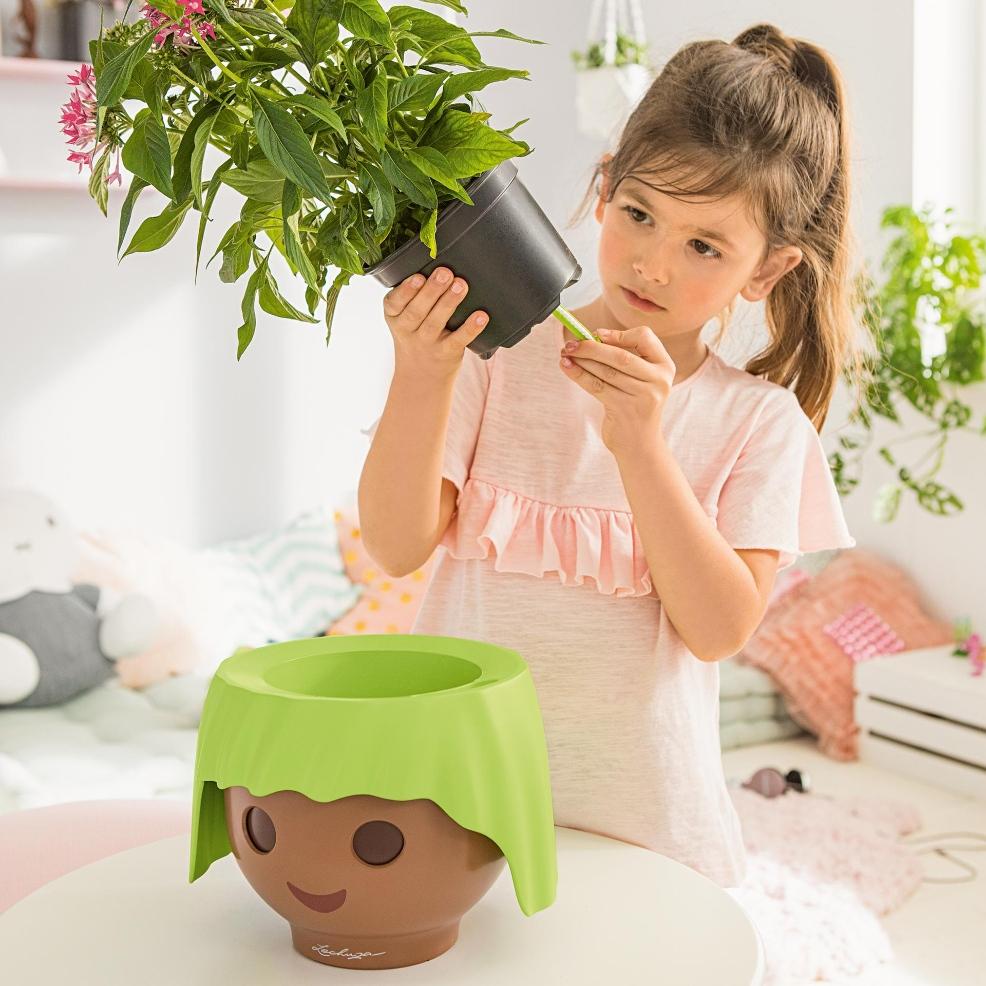 picture of a child looking after a houseplant