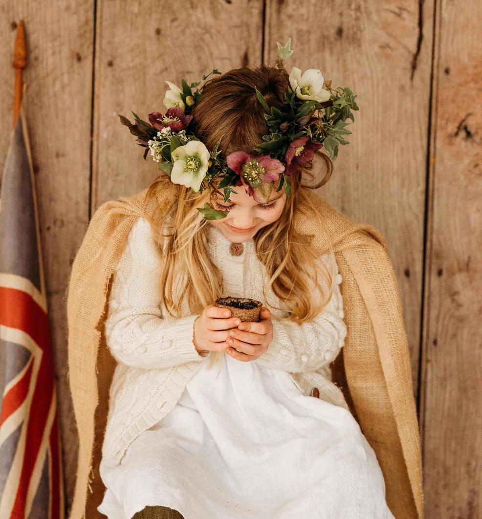 picture of child planting a tree for the jubilee