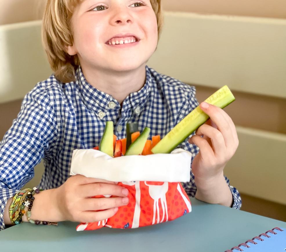 picture of a child with a zero waste snack bag