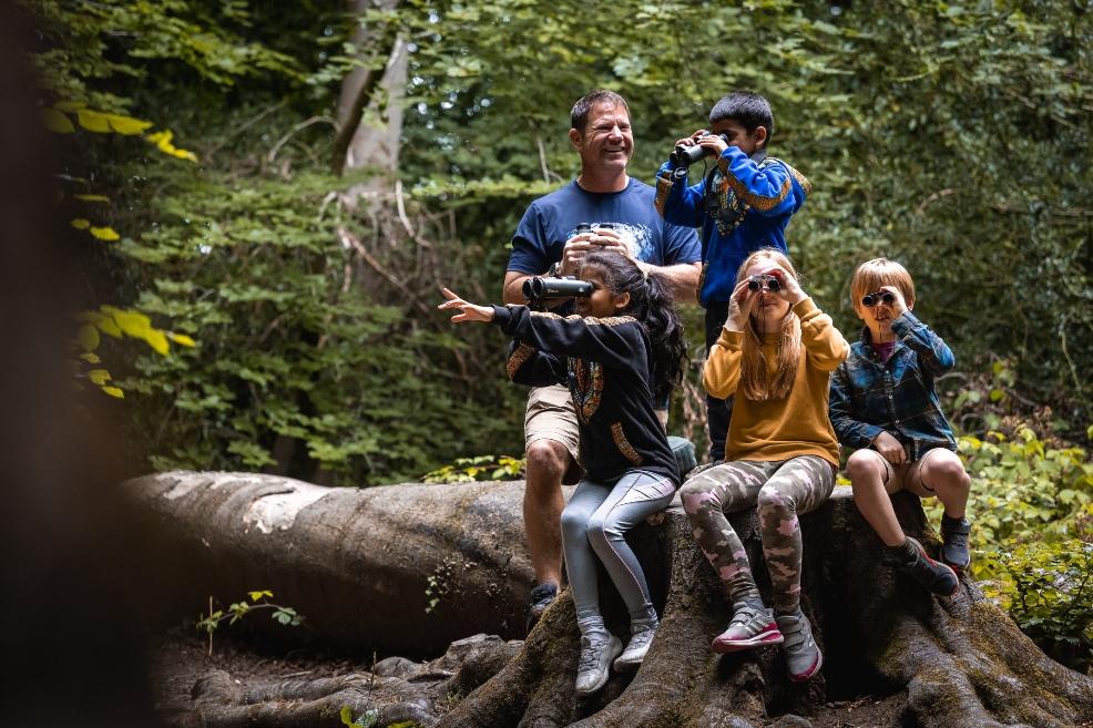 picture of steve backshall with children in the woods
