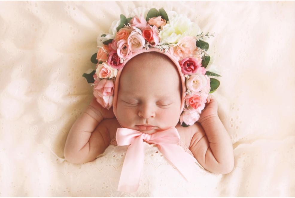 picture of a baby with a floral pink headband