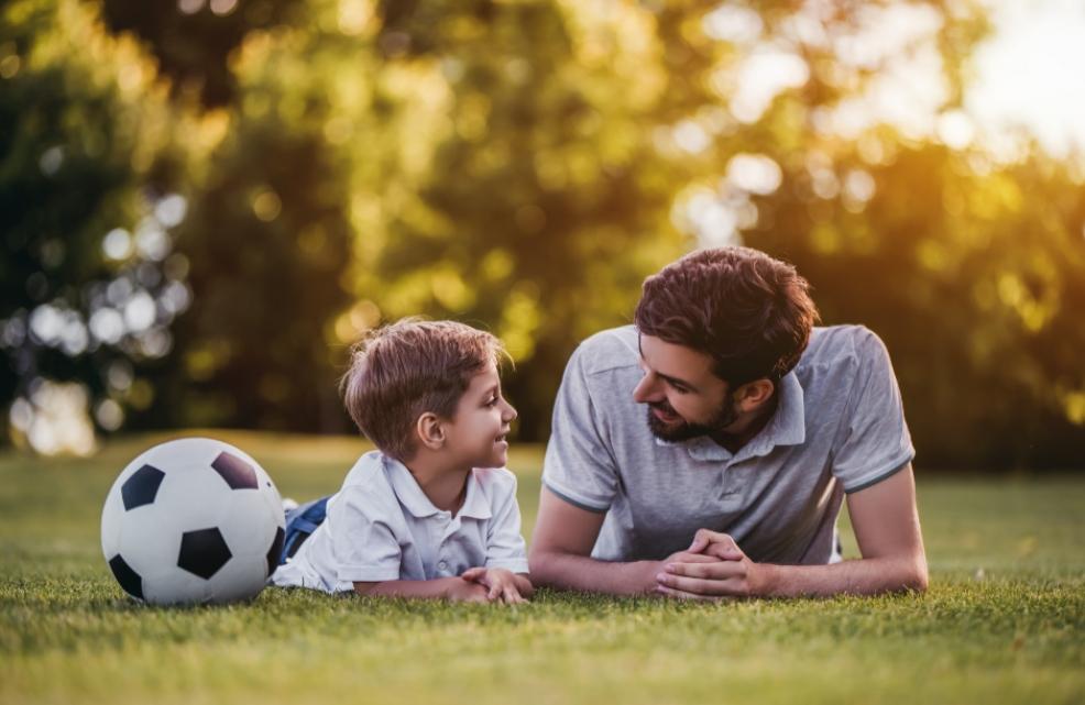 picture of father and son playing football