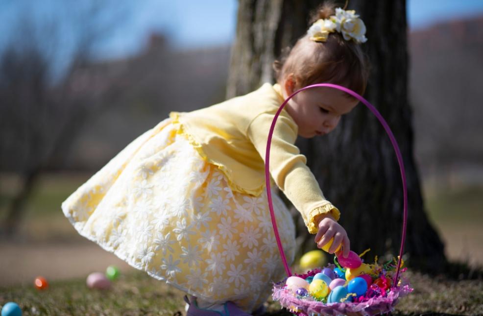 picture of a child doing an easter egg hunt outdoors