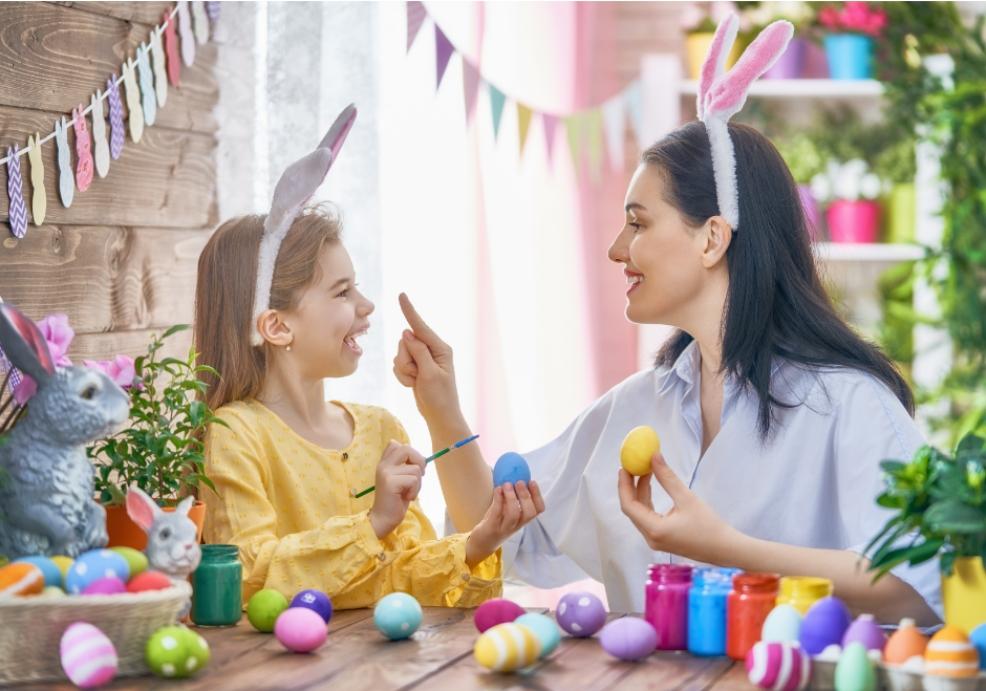 picture of mum and daughter painting easter eggs