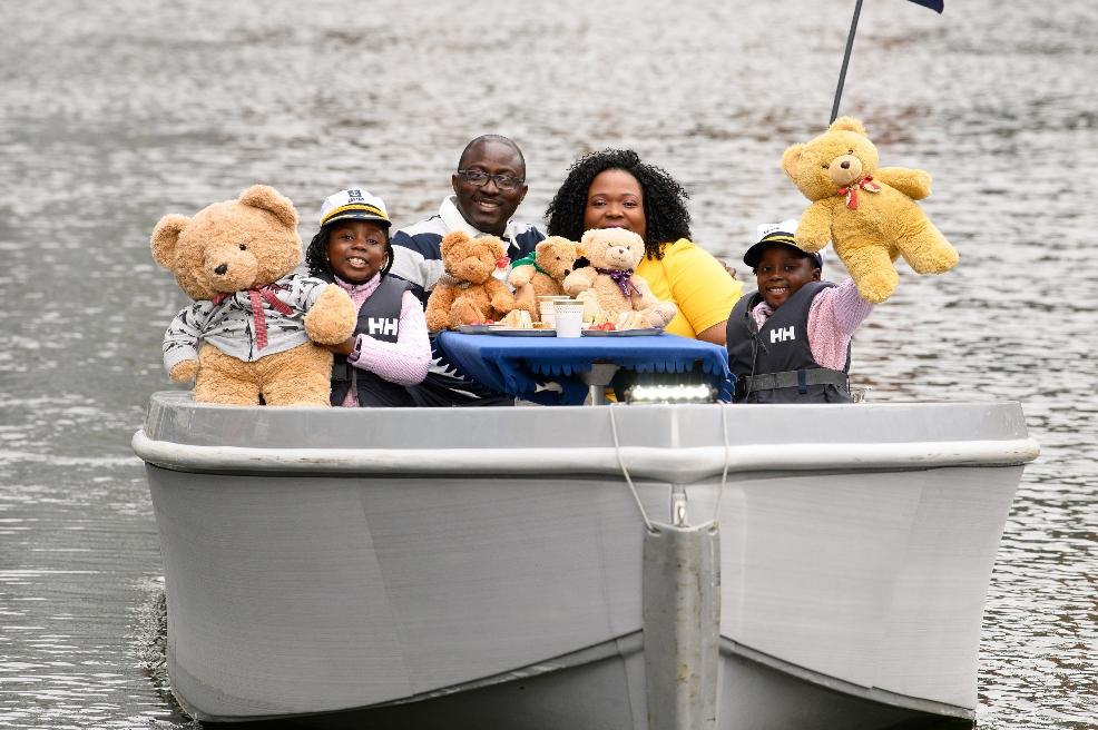 picture of a family on a boat with teddy bears
