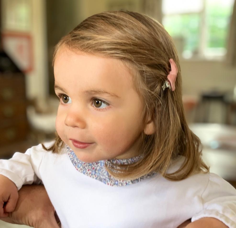 picture of a toddler girl with a ruffle top on