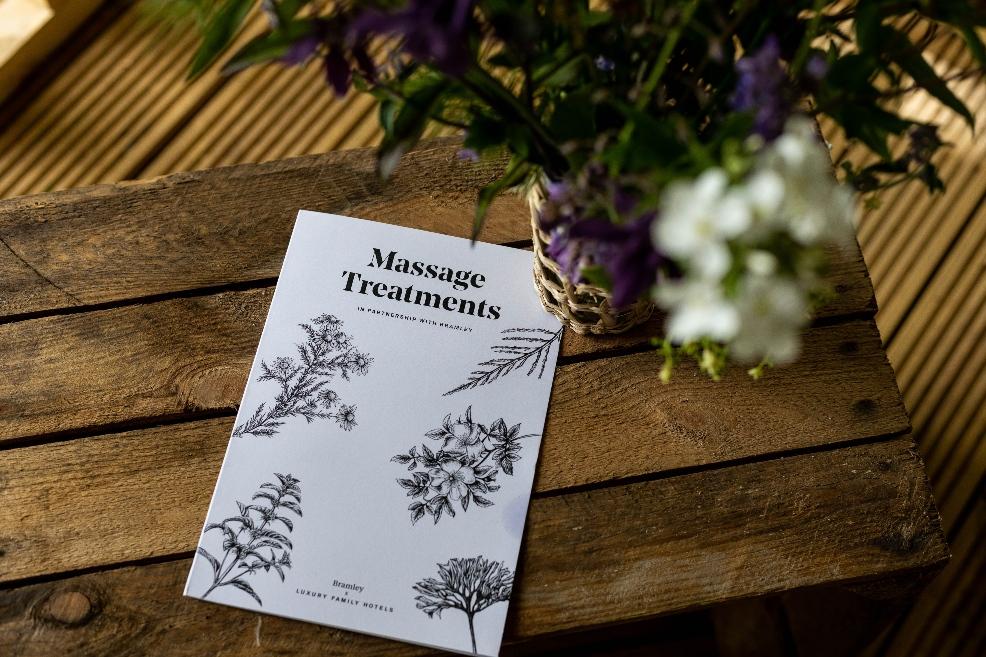 picture of a massage treatments brochure on a wooden table