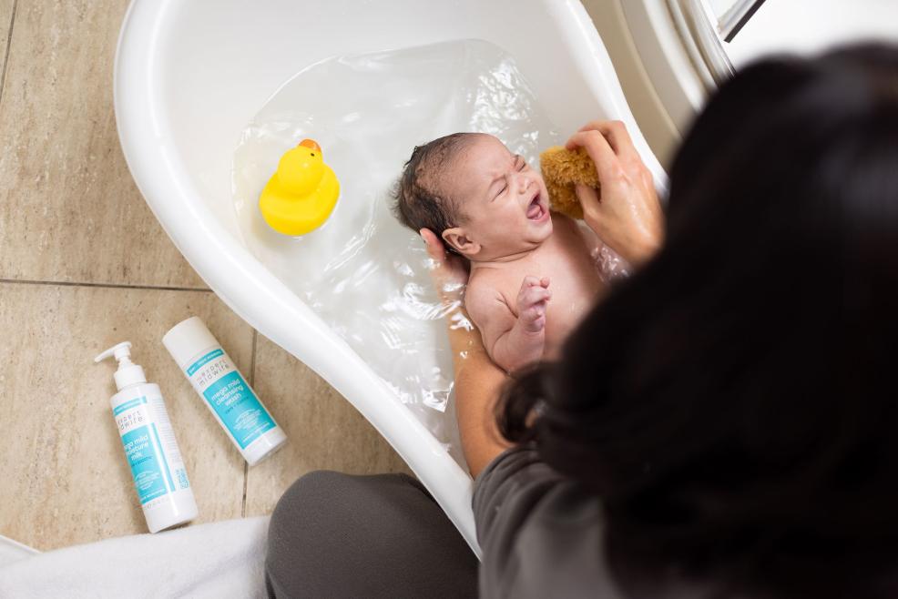 picture of A baby being bathed