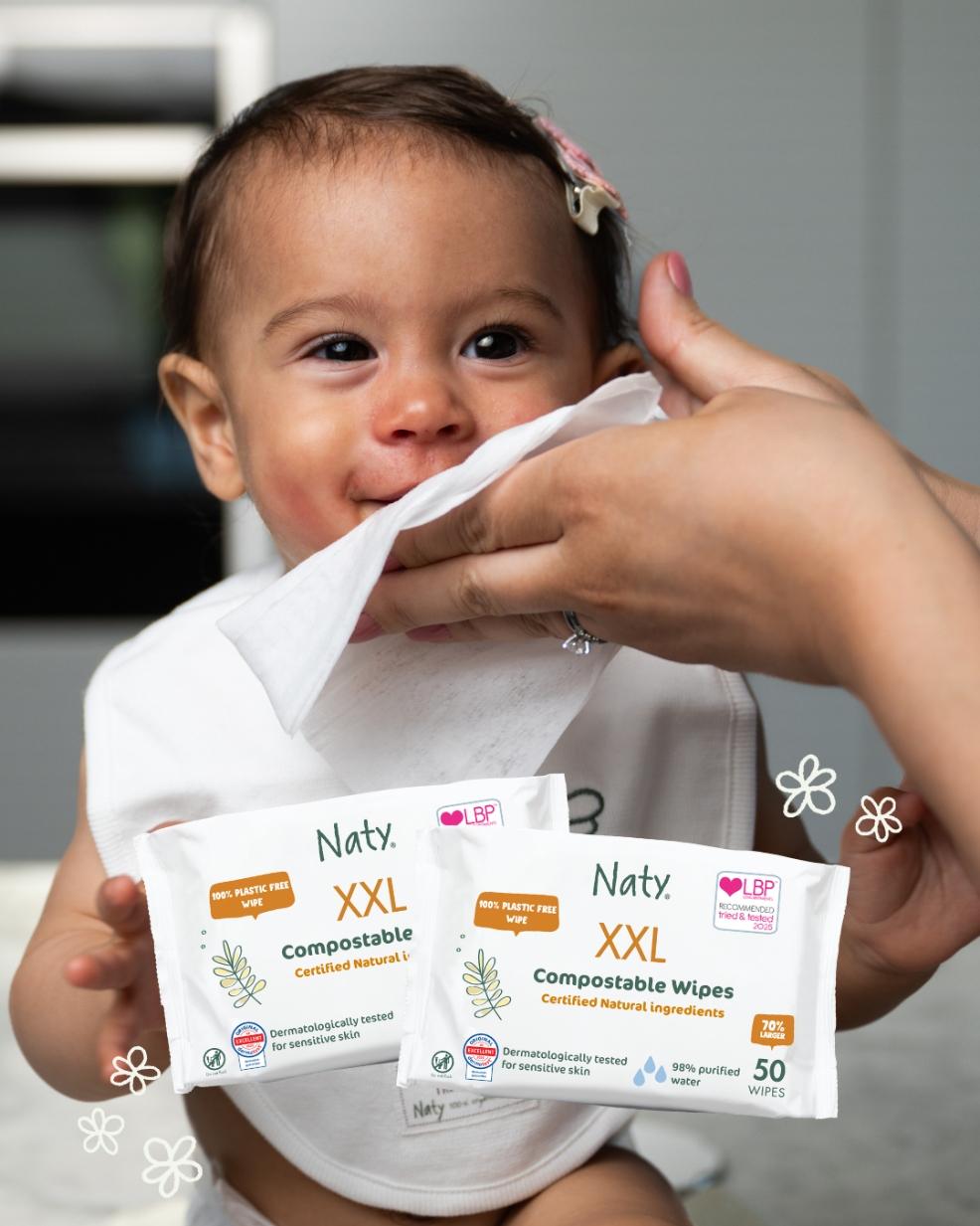 a baby having their face wiped with Naty compostable wipes picture of a baby having their face wiped with Naty compostable wipes