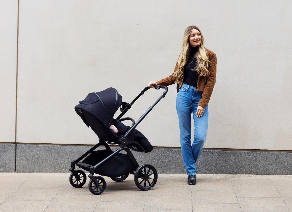 picture of a mum using a Altima Black 9 piece pushchair set