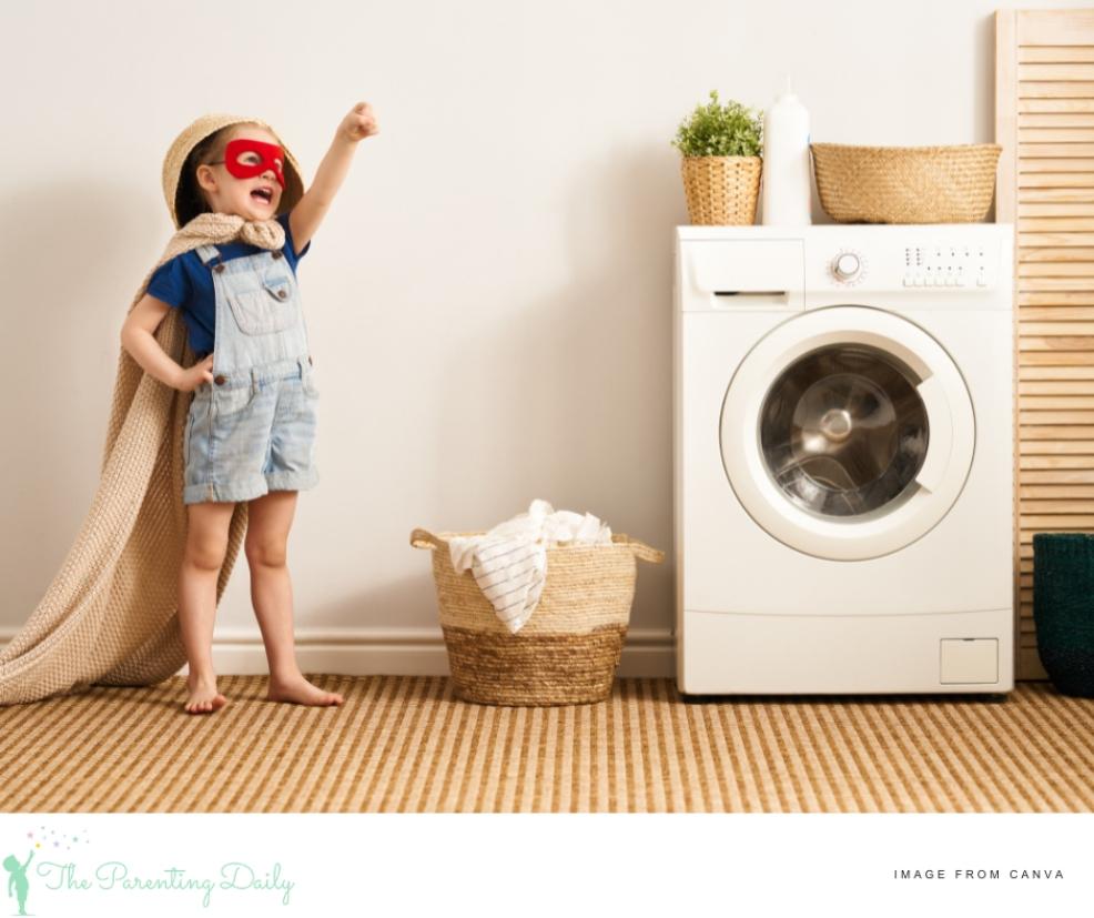 picture of a child dressed as a superhero helping doing the laundry