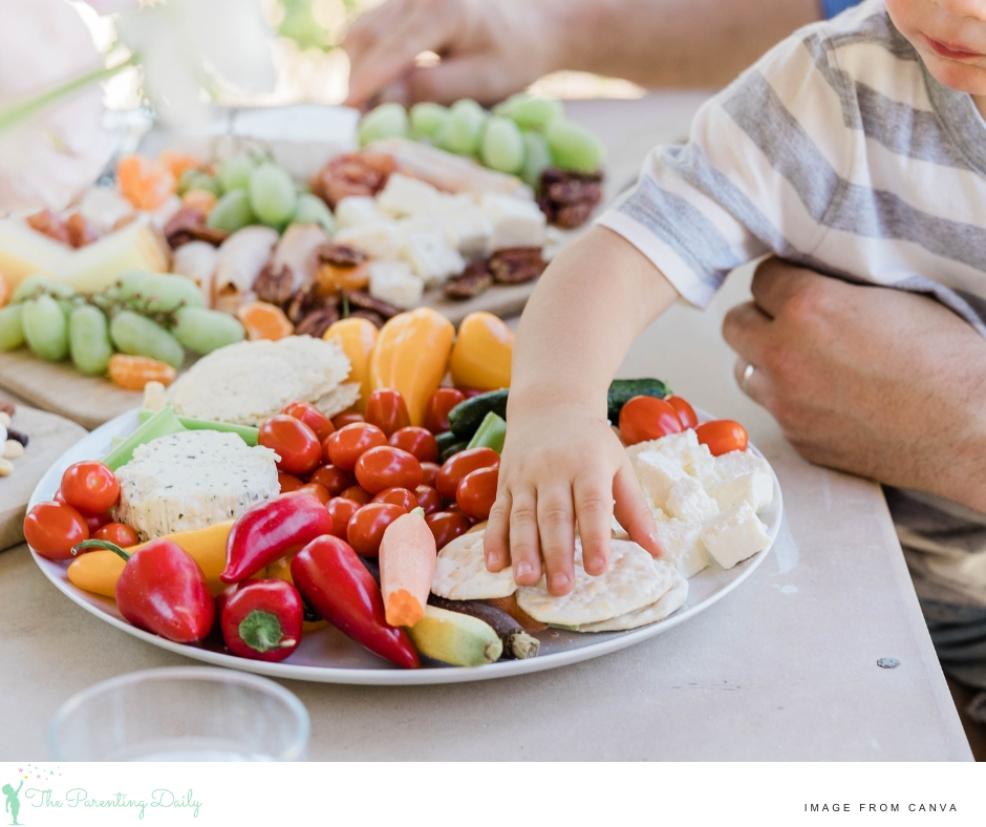 a child helping himself to a healthy platter of food picture of a child helping himself to a healthy platter of food
