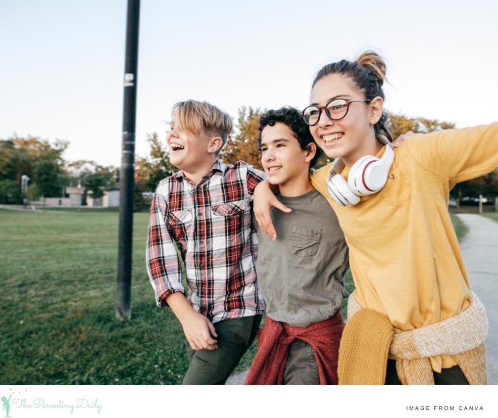 picture of a group of happy friends walking arm in arm together outside