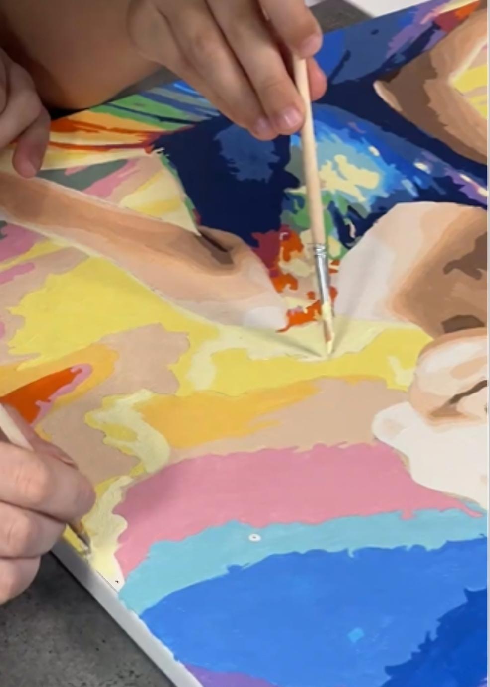 picture of a close up of someone doing a paint by numbers painting